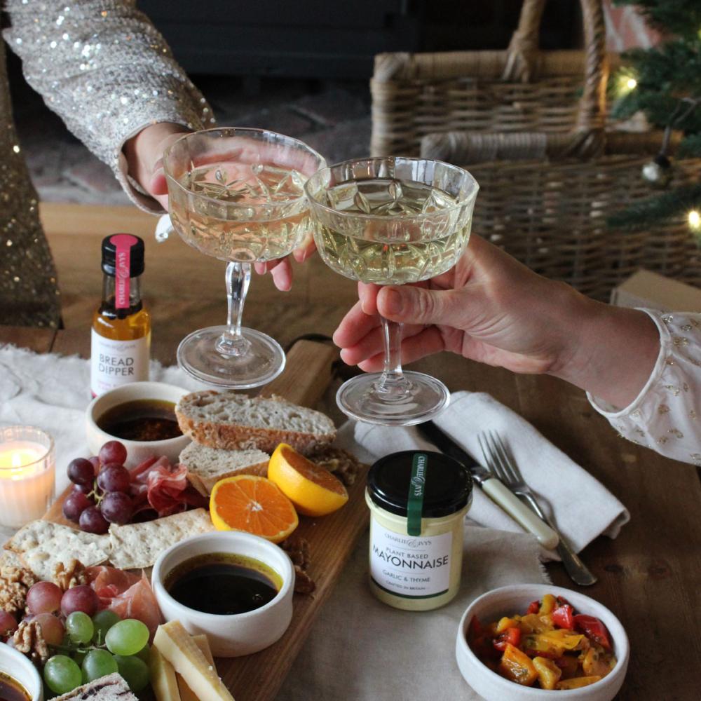 Cheers! Glasses clinking over a grazing platter