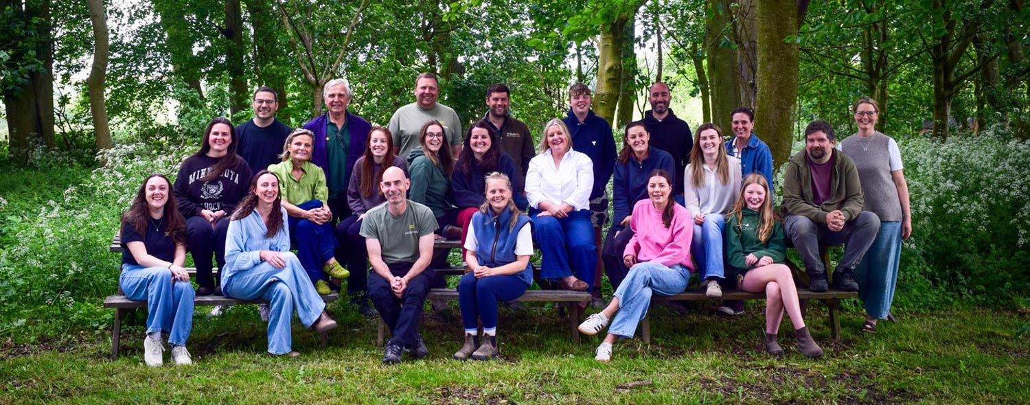 The team at Breckenholme standing in a farm field