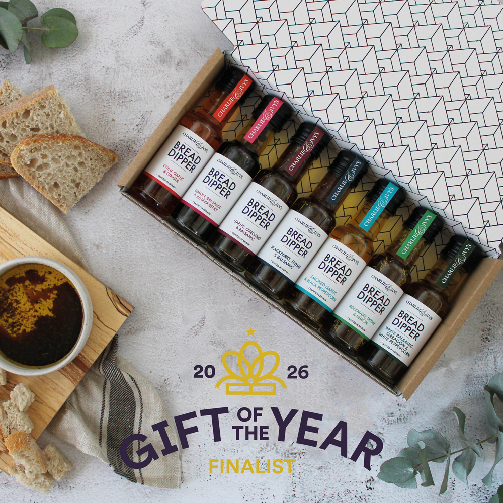 An open gift box featuring 7 mini bread dippers, alongside dipping bowls and bread