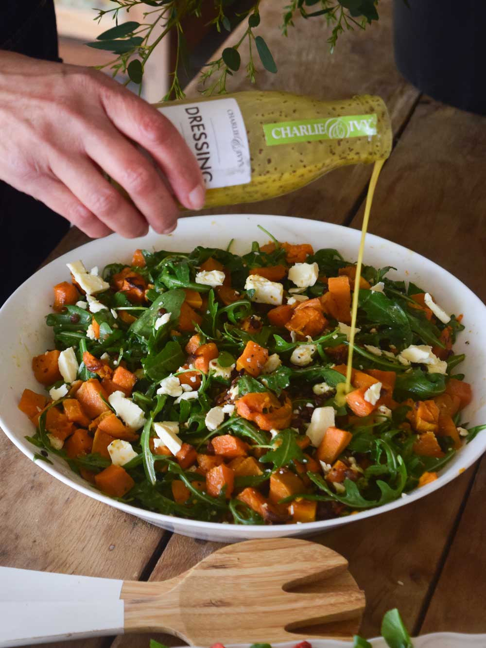 Sweet Potato Salad with a poring bottle of dressing