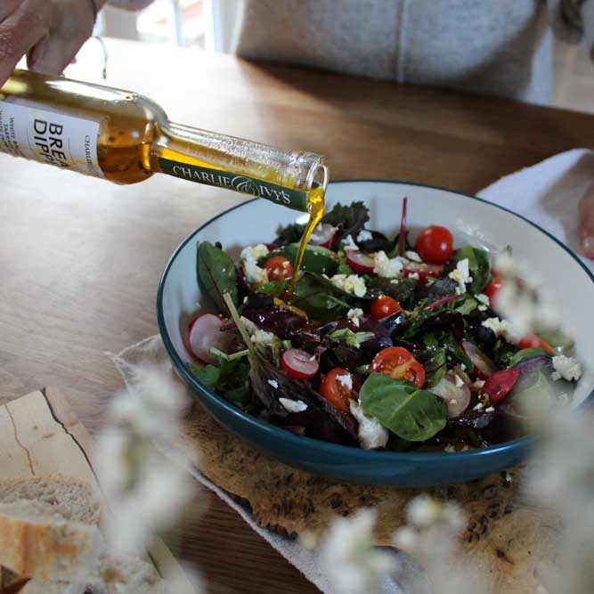 Oil pouring over salad